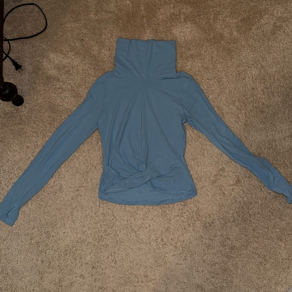 Light blue Lululemon turtleneck with crop crossing at the bottom